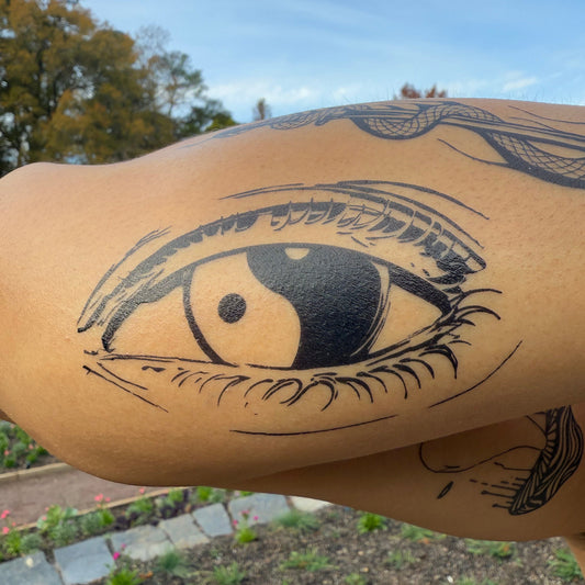 Yin & Yang Eye Temporary Tattoo applied on arm. Featuring Pure Black Ink™, lasting 1-2 weeks.
