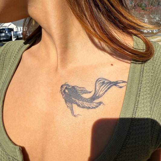 Koi fish temporary tattoo on chest, a symbol of resilience by SteezyInk