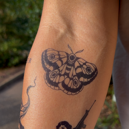 SteezyInk Bold Moth Temporary Tattoo on arm, black moth design for temporary body art, lasting up to two weeks
