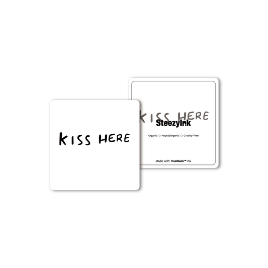 SteezyInk Kiss Here temporary tattoo, black text on white card, skin-safe body art.