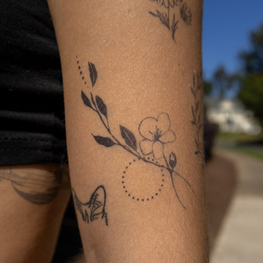 Bloom semi-permanent tattoo on arm, floral design with Pure Black Ink™, skin-safe body art