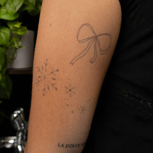 SteezyInk temporary tattoo design featuring snowflake, bow and LA DOLCE VITA words.