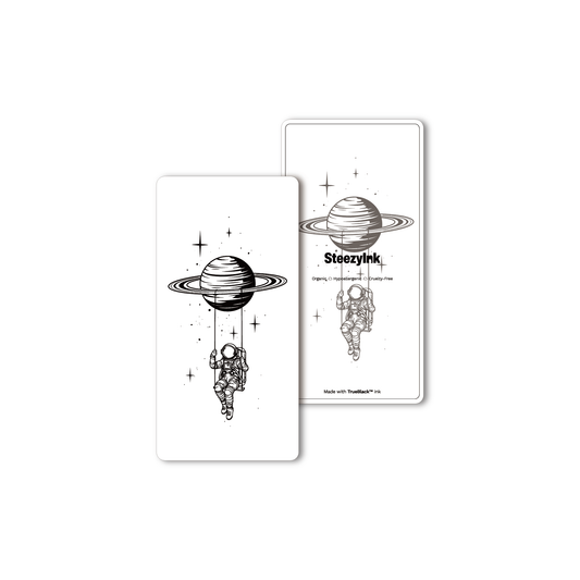 Saturn Swing Temporary Tattoo, astronaut swinging from Saturn. Made with Pure Black Ink™.