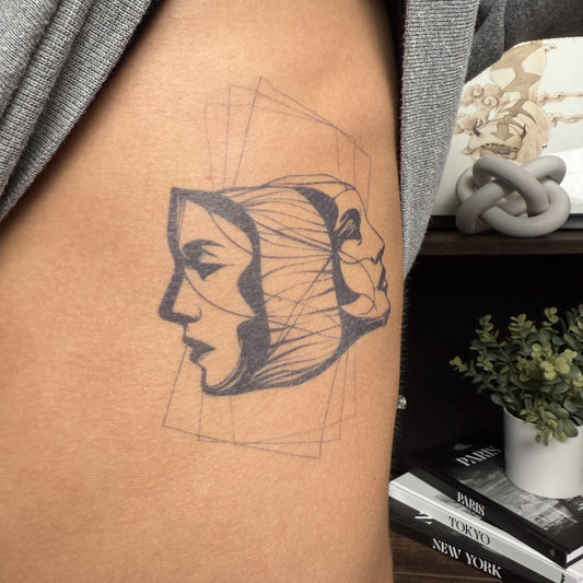Layered Minds temporary tattoo on skin, black ink design, SteezyInk semi-permanent tattoo.