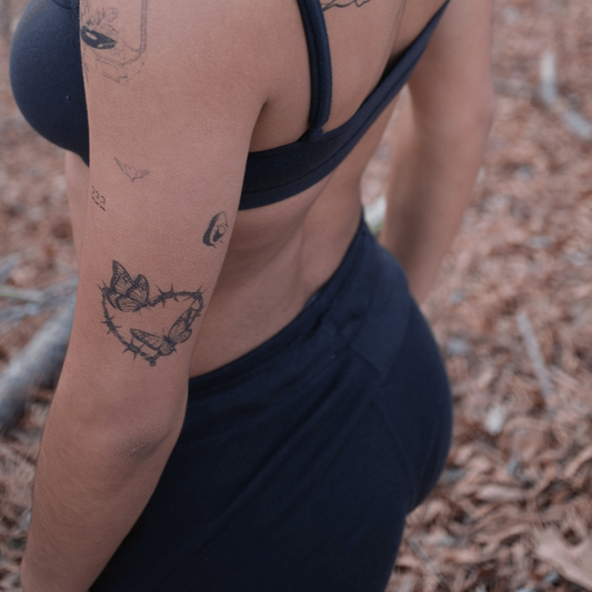 SteezyInk Butterfly Barbed Heart Temporary Tattoo on arm, representing resilience and love.