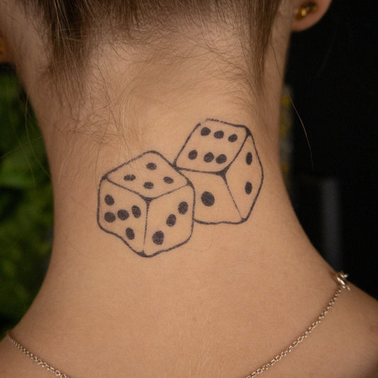 A woman's dice tattoo on the back of her neck.