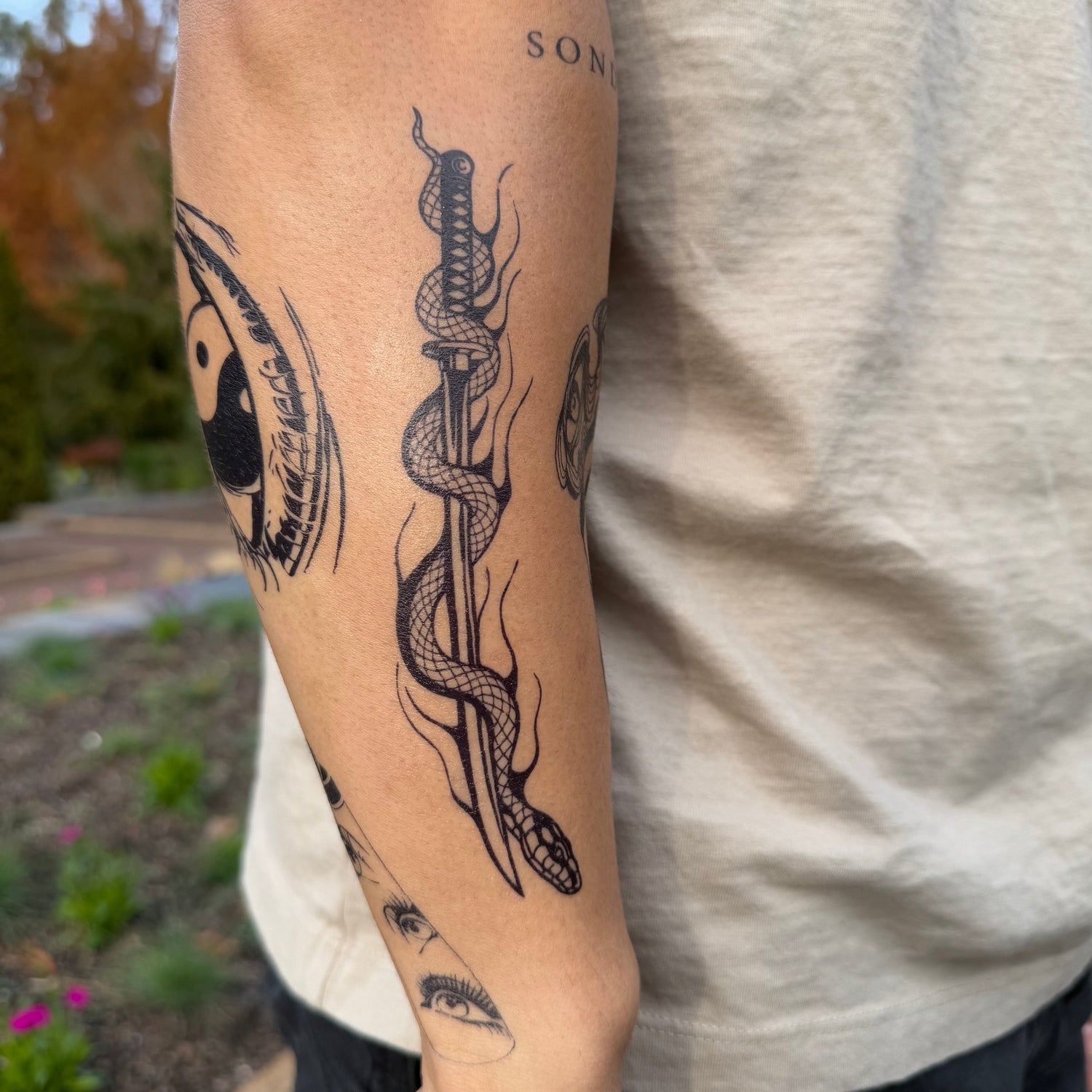 SteezyInk Katana Snake temporary tattoo on arm, semi-permanent design. Features snake and katana.