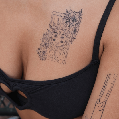 SteezyInk Radiant Sun temporary tattoo on skin, featuring floral details, and 'The Sun' card design